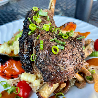 CAJUN STYLE RACK OF LAMB AND GRITS WITH GRILLED VEGETABLES