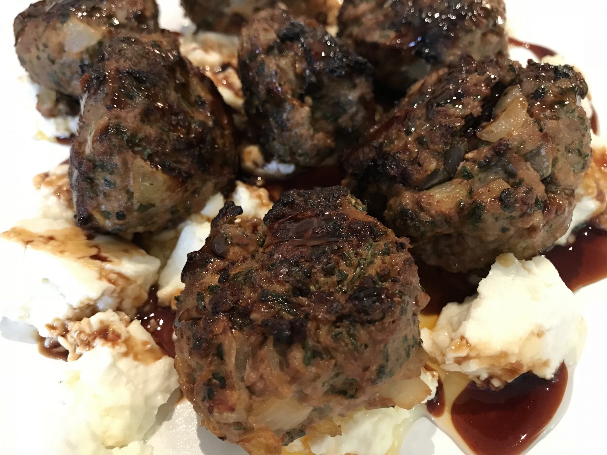 LAMB MEATBALLS WITH BAKED FETA AND POMEGRANATE MOLASSES