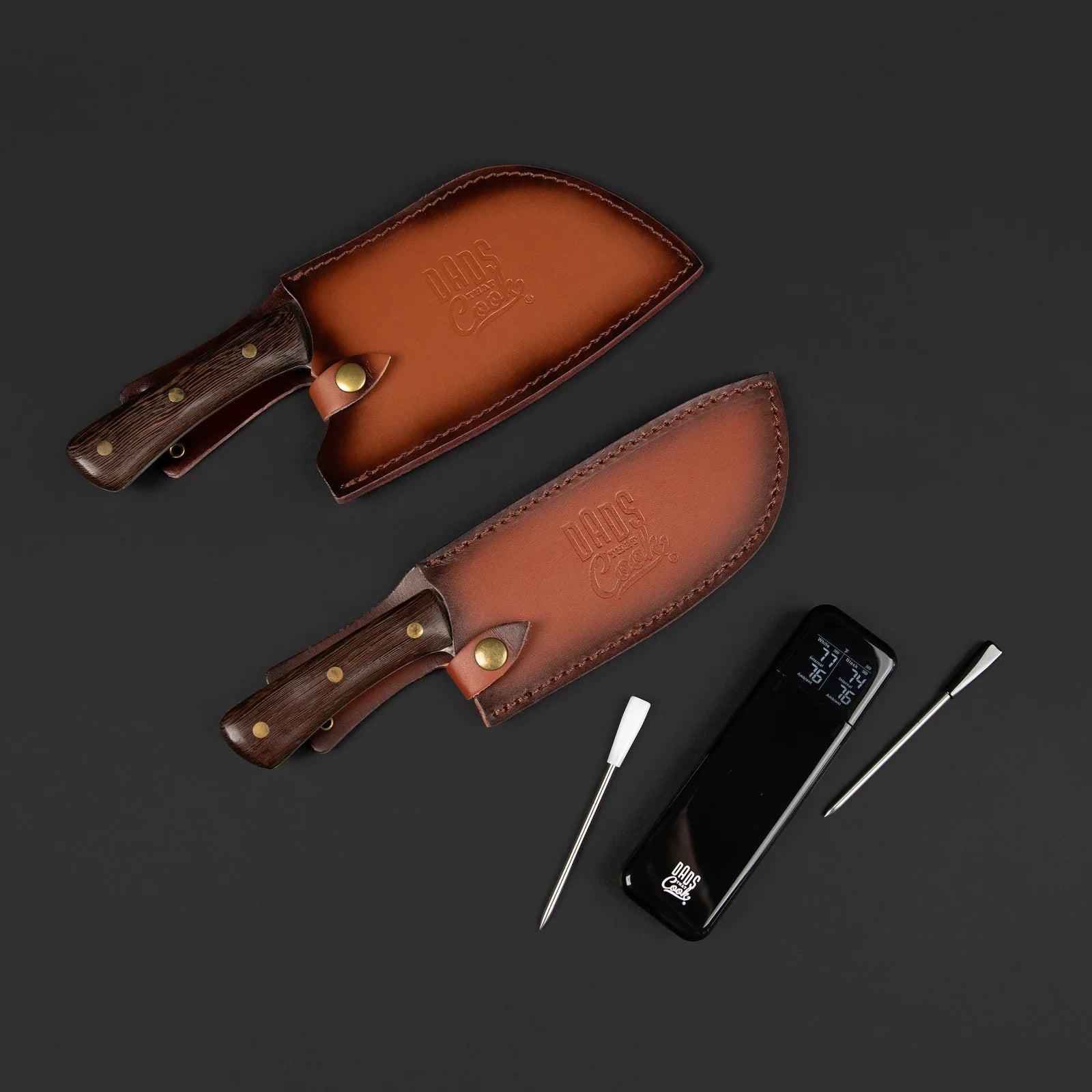 Ultimate Probe Bundle with both knives in leather sheaths beside two wireless meat probes and charging dock